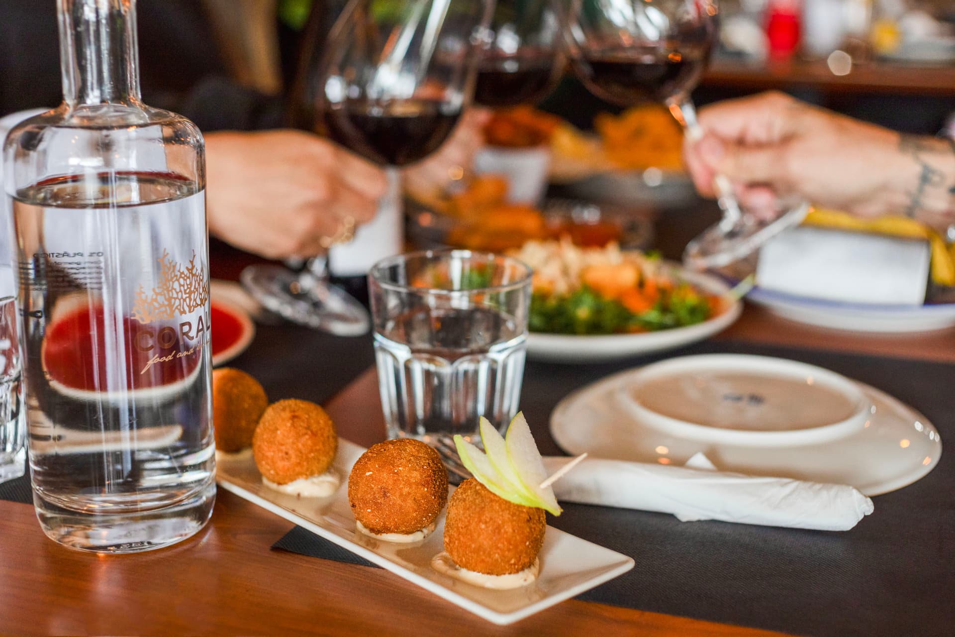 Croquetes e vinho servidos no Coral